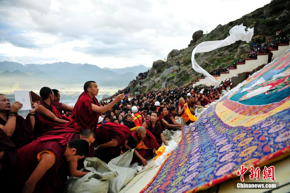 ལྷ་སའི་ཞོ་སྟོན་དུས་ཆེན་འགོ་བརྩམས་པས་དད་ལྡན་མང་ཚོགས་དང་ཡུལ་སྐོར་བས་འབྲས་སྤུངས་དགོན་གྱི་གོས་སྐུར་མཇལ་བཞིན་པ།